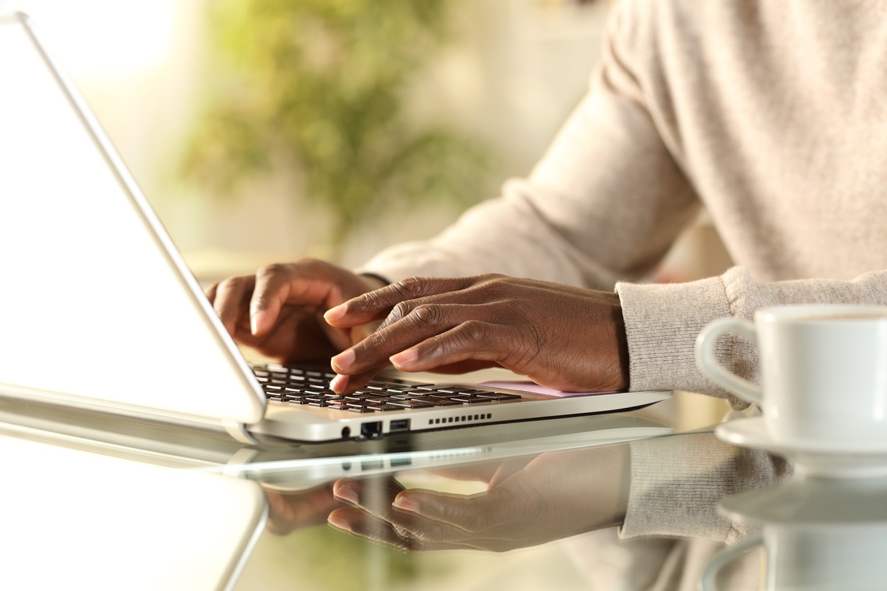 Man's hands typing on laptop