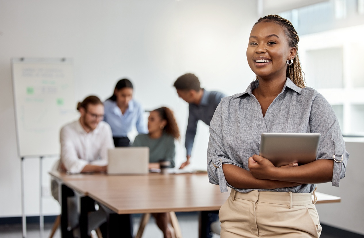 Woman holding computer with confidence